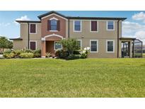 Charming townhome with lush landscaping and a well-manicured lawn creates an inviting curb appeal at 11617 Crowned Sparrow Ln, Tampa, FL 33626