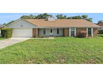 Charming one-story home with a well-manicured lawn, attached garage and inviting front porch at 2308 Long Green Ct, Valrico, FL 33596