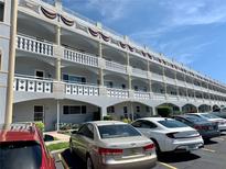 Condo building featuring multiple levels with balconies and ample parking at 2410 Franciscan Dr # 18, Clearwater, FL 33763