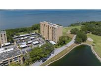 Scenic aerial view of a high-rise condo building near the water and a golf course at 2617 Cove Cay Dr # 707, Clearwater, FL 33760