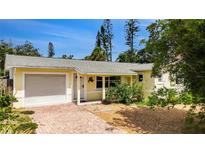 Charming single-story home with a brick driveway, well-maintained landscaping, and a welcoming front porch at 2807 Miriam S St, Gulfport, FL 33711
