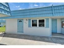 Charming home featuring a light blue roof, decorative shutters, and a neatly maintained exterior at 302 Andover Pl # G156, Sun City Center, FL 33573