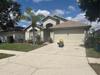 Charming single-story home with well-maintained landscaping, neutral exterior, and attached two-car garage at 4436 Horseshoe Pick Ln, Valrico, FL 33594