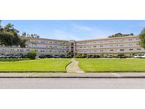 Well-maintained condo building with mature landscaping and ample parking at 5725 80Th N St # 301, St Petersburg, FL 33709