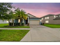 Charming single-Gathering home with a well-manicured lawn, mature trees, and a two-car garage at 9816 Ivory Dr, Sun City Center, FL 33573