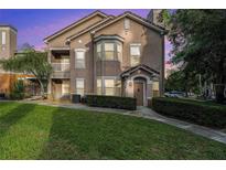Inviting home exterior with well-manicured lawn and lush landscaping; featuring a charming entrance and bay window at 10436 Villa View Cir, Tampa, FL 33647