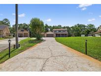 Two story home features a textured driveway, attached garage, and well-manicured lawn at 1357 Dinsmore Ct, New Port Richey, FL 34655