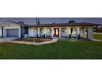 Charming single Gathering home featuring a lovely front yard and an arched walkway at 140 88Th Ne Ave, St Petersburg, FL 33702