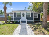 Charming bungalow with gray siding, white trim, well-kept lawn, and a decorative walkway leading to the front door at 2026 Union S St, St Petersburg, FL 33712