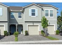 Inviting two-story home exterior featuring a two car garage, and manicured landscaping at 2507 Arbor Wind Dr, Lutz, FL 33558