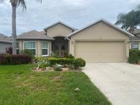 Charming single-story home with well-manicured lawn, fresh landscaping and an attached two car garage at 29702 Tee Shot Dr, San Antonio, FL 33576
