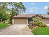 Lovely home with a two-car garage, stone accents, and neatly manicured front yard at 3902 Shoreside Cir, Tampa, FL 33624