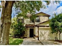 Charming two-story home features a well-manicured lawn, mature trees, and an attached two-car garage at 5110 Corvette Dr, Tampa, FL 33624