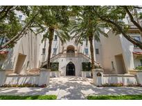 Elegant condominium exterior with a gated entrance and lush palm trees along the entry stairs at 610 S Rome Ave # 602, Tampa, FL 33606