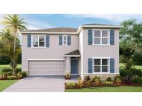 Charming two-story home featuring blue shutters, a two-car garage, and well-maintained landscaping at 7136 Beaverhead Ln, Land O Lakes, FL 34638