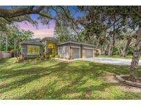 Charming single-Gathering home with a well-manicured lawn and a three car driveway at 7809 E 114Th Ave, Temple Terrace, FL 33617