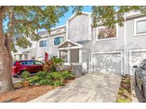 Charming townhome with a one-car garage and a covered front porch at 9660 Tara Cay Ct # 38, Seminole, FL 33776