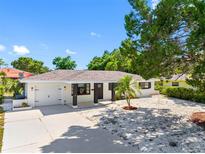 Charming single-story home with a well-manicured lawn, white rock landscaping, and a one car garage at 1154 64Th S Ave, St Petersburg, FL 33705