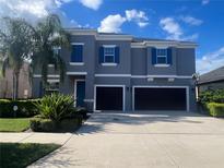 Charming two-story home featuring a well-maintained yard and a convenient two-car garage at 33191 Azalea Ridge Dr, Wesley Chapel, FL 33545