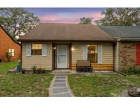 Charming single-story home with neutral siding, white shutters, and a cozy front bench at 35077 Whispering Oaks Blvd, Dade City, FL 33523