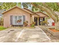 Charming single-story home with brick accents, a cozy porch, and colorful landscaping at 4613 Summerwind Ct, Plant City, FL 33566
