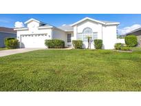 Charming single-story white home with a lush green lawn and mature landscaping at 5017 46Th W St, Bradenton, FL 34210