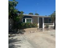 Charming single-story home featuring a bay window, a stone-paved front yard and elegant white columns and railing at 5106 Gateway Dr, Tampa, FL 33615