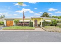 Charming single-story home featuring a well-manicured front yard and inviting entrance at 5821 52Nd N Ave, Kenneth City, FL 33709