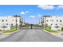 Community entrance showcasing modern townhomes and gated access, promoting security and upscale living at 6206 64Th N Way, Pinellas Park, FL 33781