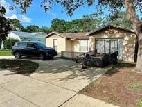 Charming single-story home with a concrete driveway, lush landscaping, and a convenient attached garage at 8801 Orange Blossom Dr, Seminole, FL 33772