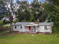Charming single-story home with inviting front porch and lush green lawn, perfect for relaxation and outdoor enjoyment at 11704 Orange Grove Ter, Riverview, FL 33569