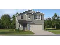 Charming two-story home with a gray exterior, attached garage, and well-maintained landscaping at 11716 Brae Way, Dade City, FL 33525