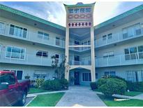 Beautiful condominium building with three levels and a uniquely decorated entryway at 2070 World Parkway Blvd # 36, Clearwater, FL 33763