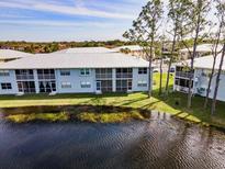 Waterfront condo featuring a screened patio with gorgeous views of the pond and lush landscaping at 25050 Sandhill Blvd # 8B1, Punta Gorda, FL 33983