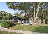 Charming single-Gathering home featuring a beautiful stone accent and mature tree in the front yard at 3753 Thornbush Ln, New Port Richey, FL 34655