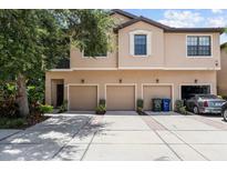 Charming townhome with three garage doors and a well-maintained concrete driveway at 4103 Via Piedra Cir # 10-101, Sarasota, FL 34233
