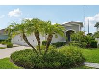 Well-manicured front yard with palm trees and lush landscaping enhances curb appeal of this lovely single-Gathering home at 13524 Circa Crossing Dr, Lithia, FL 33547