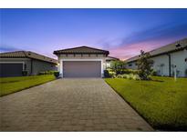 Charming single-Gathering home featuring a tile roof, attached garage and manicured landscaping at 3312 Francoa Dr, Odessa, FL 33556