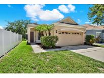 Charming single-story home with well-manicured lawn and attached two-car garage at 406 Laguna Mill Dr, Ruskin, FL 33570