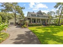 Inviting two-story home with a charming front porch and manicured lawn at 523 2Nd Sw Ave, Lutz, FL 33548