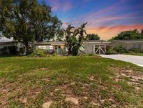 Charming single-story home with a well-manicured lawn, palm trees and delightful curb appeal at 5514 7Th N Ave, St Petersburg, FL 33710