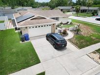 Inviting single Gathering home featuring a two-car garage, solar panels, and well-maintained landscaping at 8110 Damara Dr, New Port Richey, FL 34653