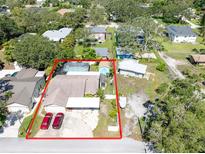 Aerial view of a home with a pool and a spacious, fully-fenced backyard, outlined in red for property boundary at 11996 117Th St, Seminole, FL 33778