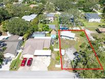 Aerial view of property showing the house, additional building, driveway, and surrounding land at 12037 1/2 Murray Ave, Seminole, FL 33778