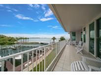 Spacious tiled balcony with views of the boat docks and sparkling waters, perfect for relaxing or entertaining guests at 2 Seaside Ln # 203, Belleair, FL 33756