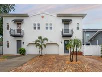 Charming two-story white home featuring stylish black awnings and a brick driveway at 403 S Fremont Ave # 3, Tampa, FL 33606