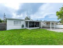 Single story home with a cozy enclosed patio and a convenient carport at 4705 Murray Hill Dr, Tampa, FL 33615