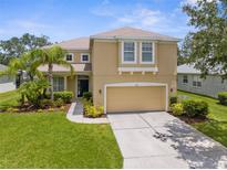 Charming two-story home featuring a two-car garage, mature landscaping, and a well-manicured lawn at 5015 58Th E Ter, Bradenton, FL 34203