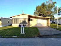 Charming single-story home with well-maintained lawn and covered parking at 6443 Midland St, Zephyrhills, FL 33542