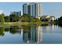 A picturesque view of the building from across the serene lake at 777 3Rd N Ave # 1704, St Petersburg, FL 33701